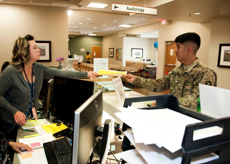 Patient administration staff assist a soldier at William Beaumont Army Medical Center