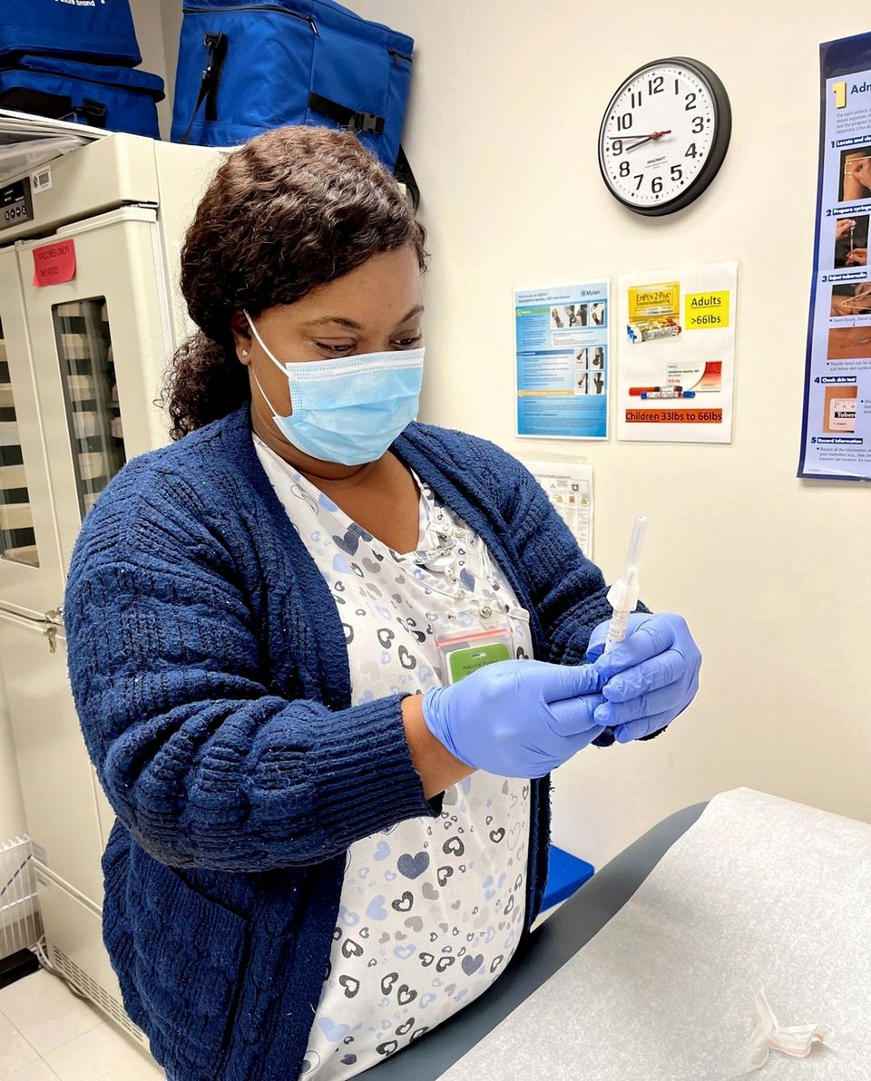 A nurse prepares a vaccine at Branch Health Clinic Albany