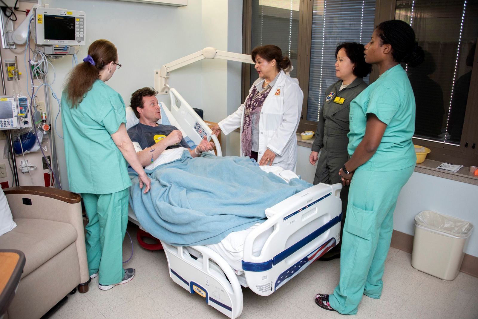 Nurses confer with a patient at Brooke Army Medical Center